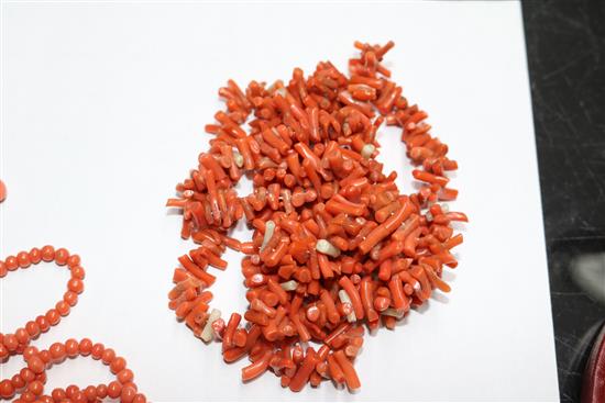 A group of assorted coral jewellery, including necklaces.